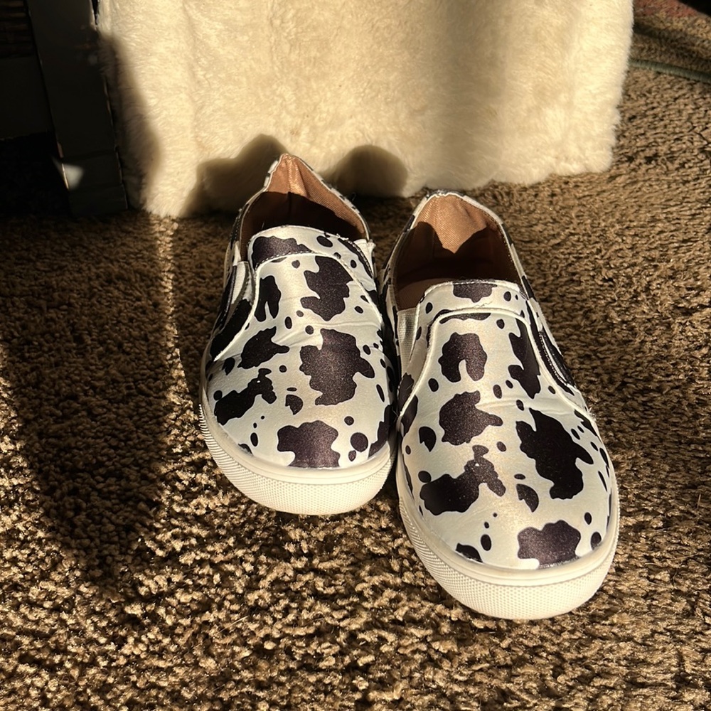 Women’s cow print slip on shoes